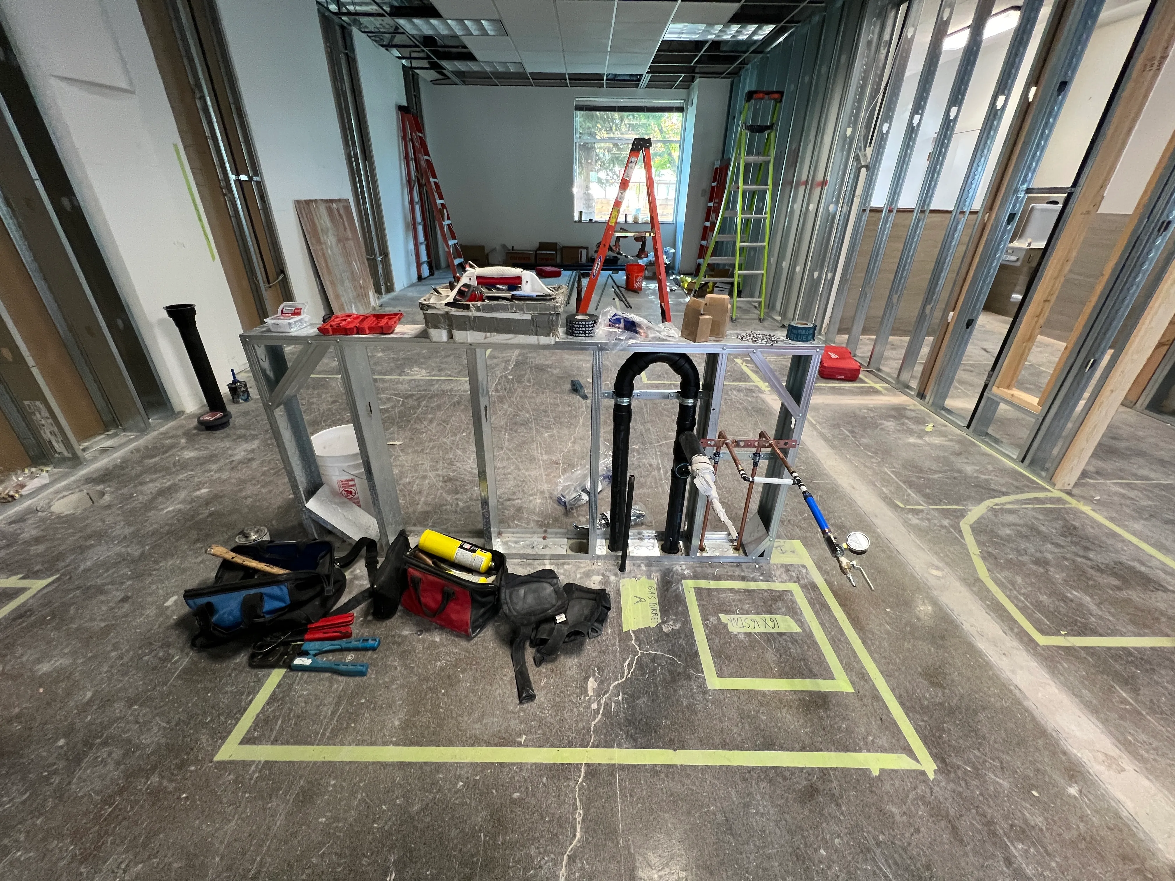 Lab station framing and rough-in with floor layout marked