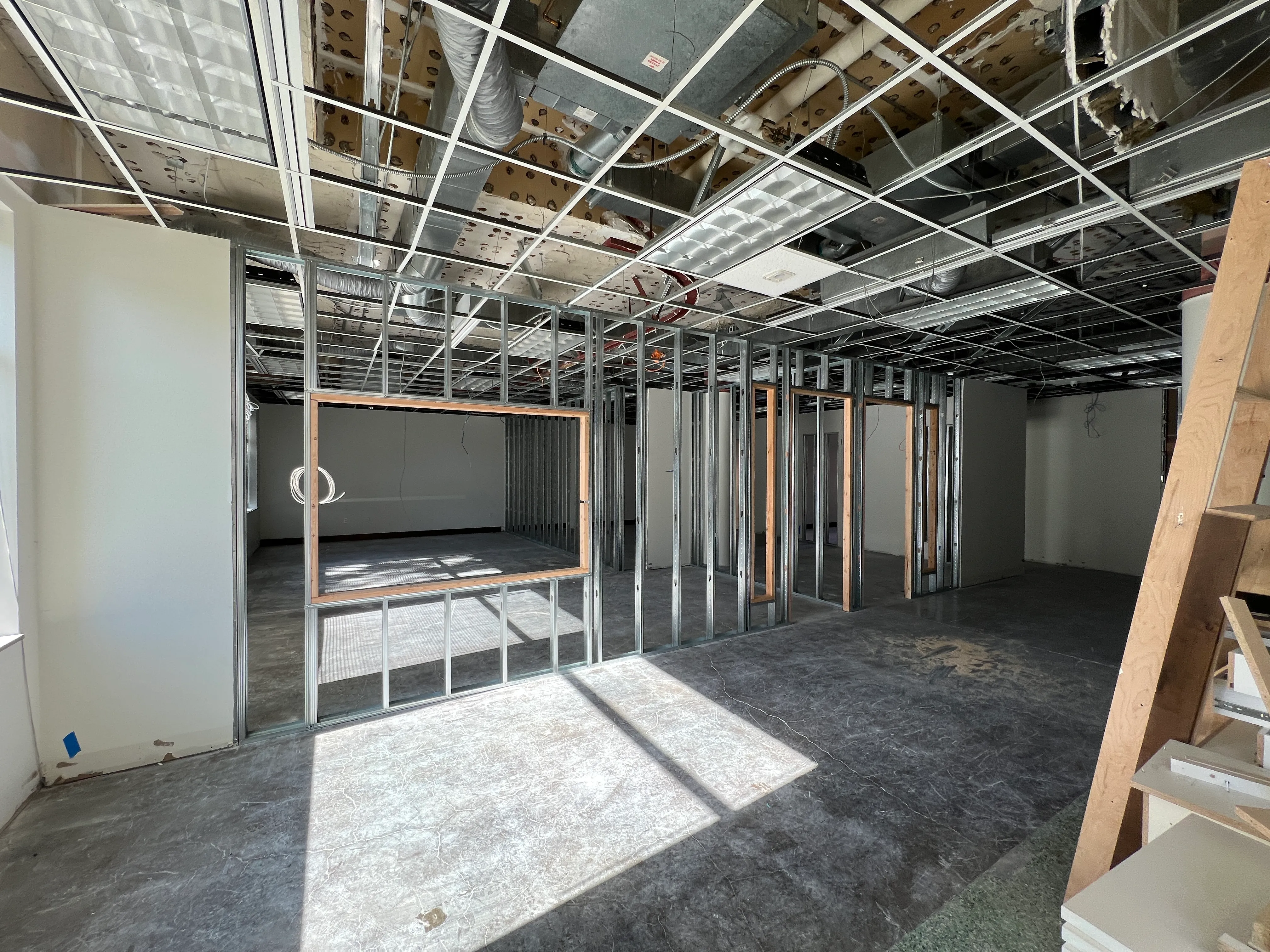 Classroom wall framing with window opening and open ceiling grid