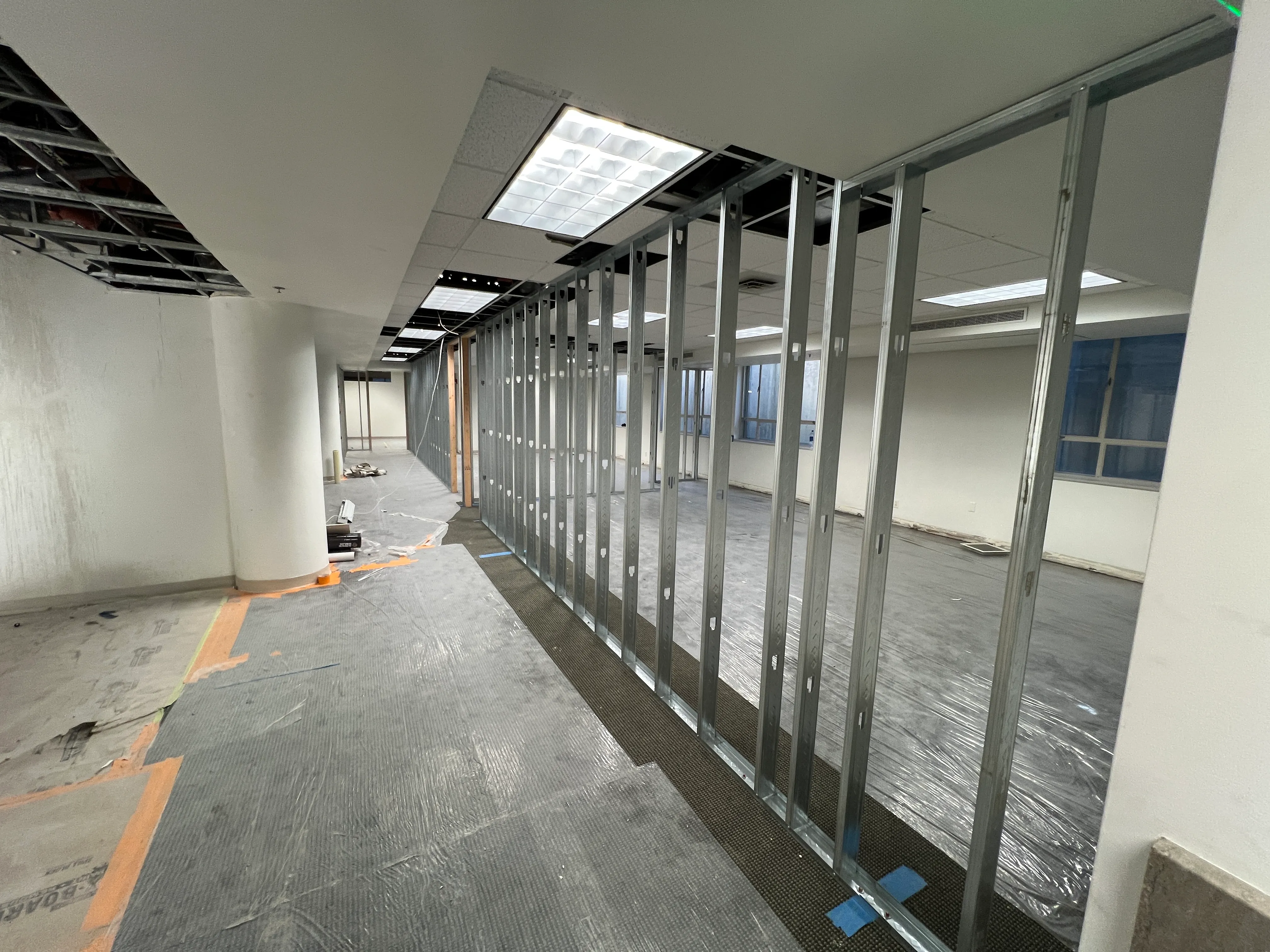 Long run of steel stud framing along the corridor