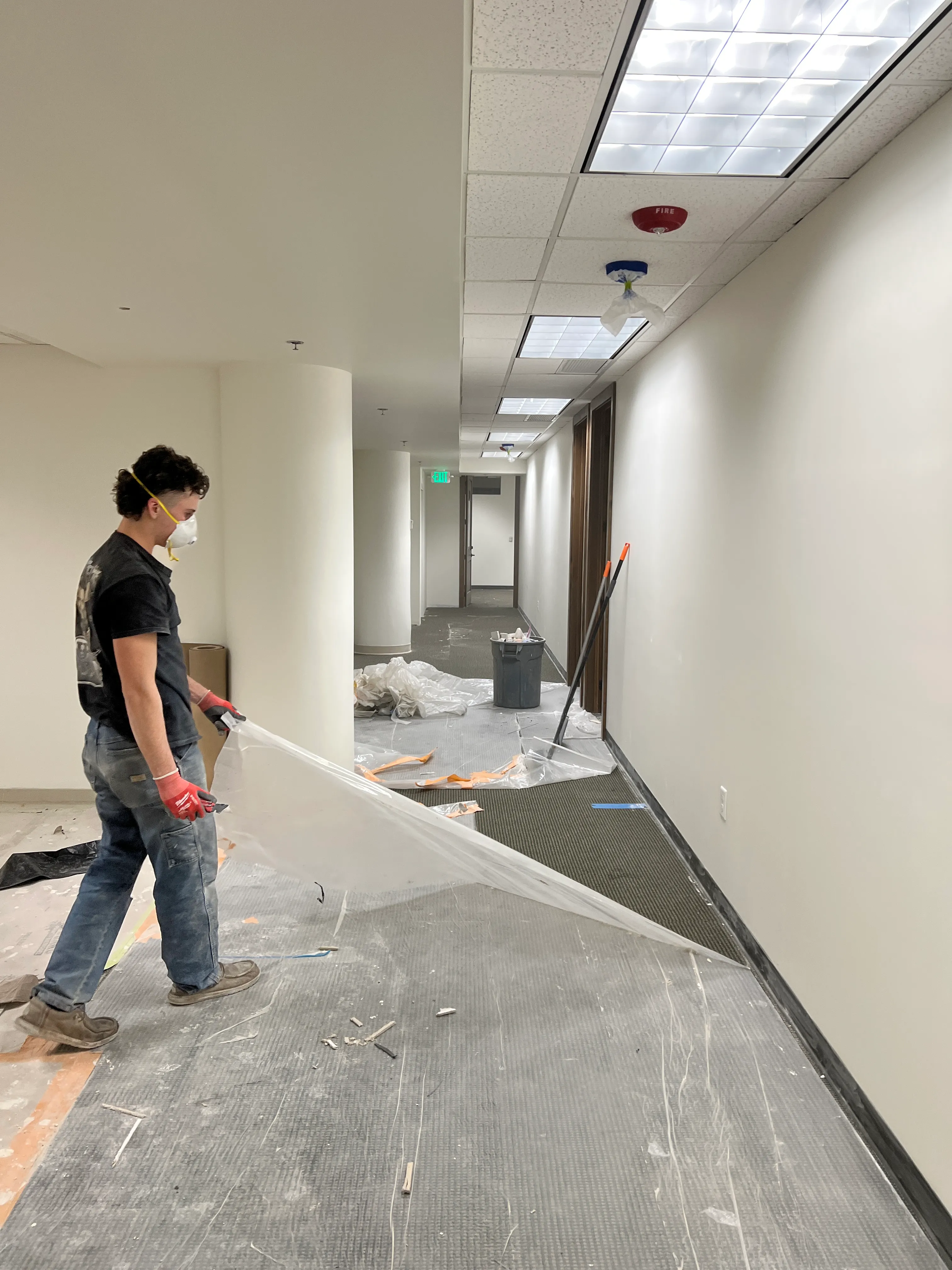 Hallway floor protection being pulled during finish work