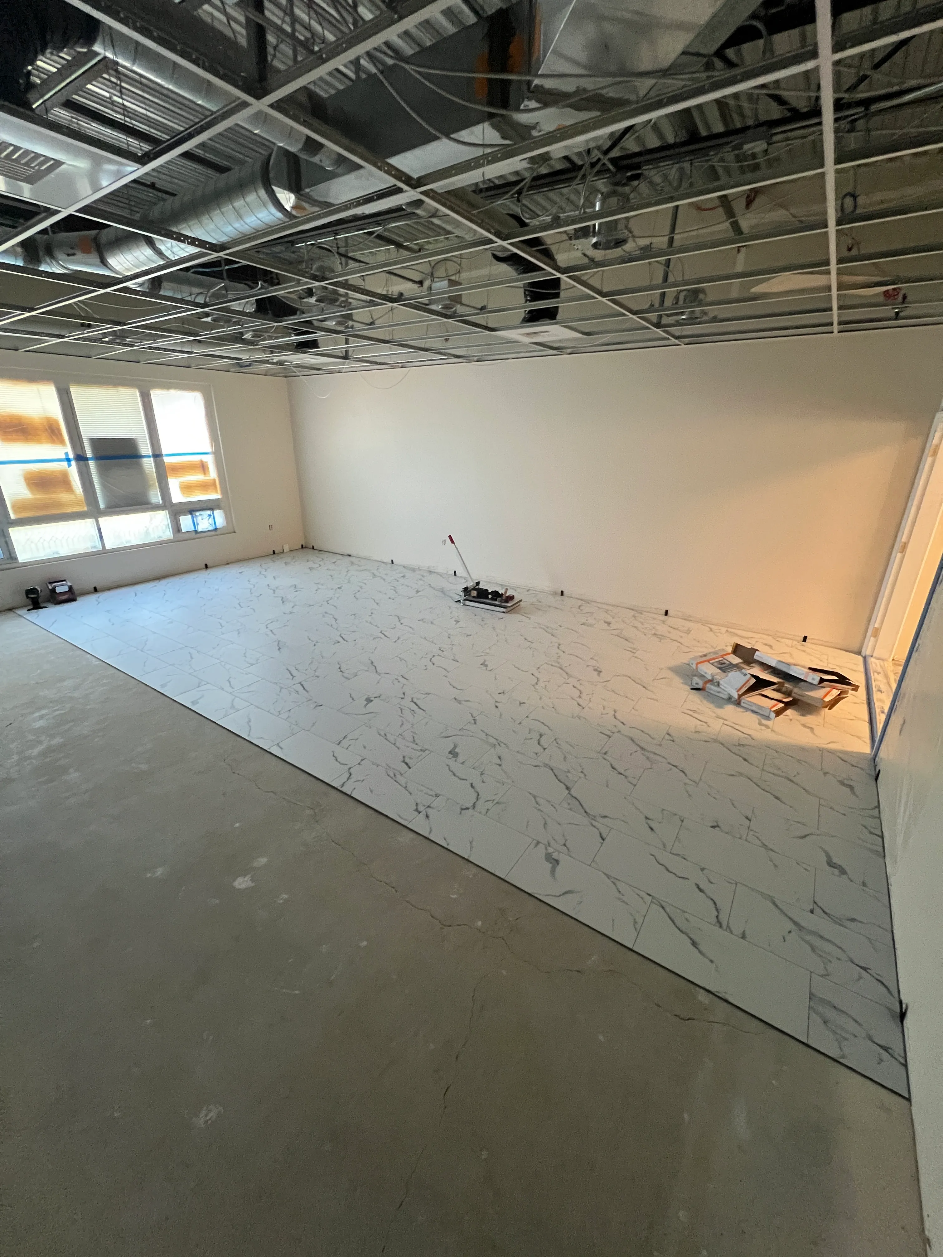 Marble-look tile being set on wall