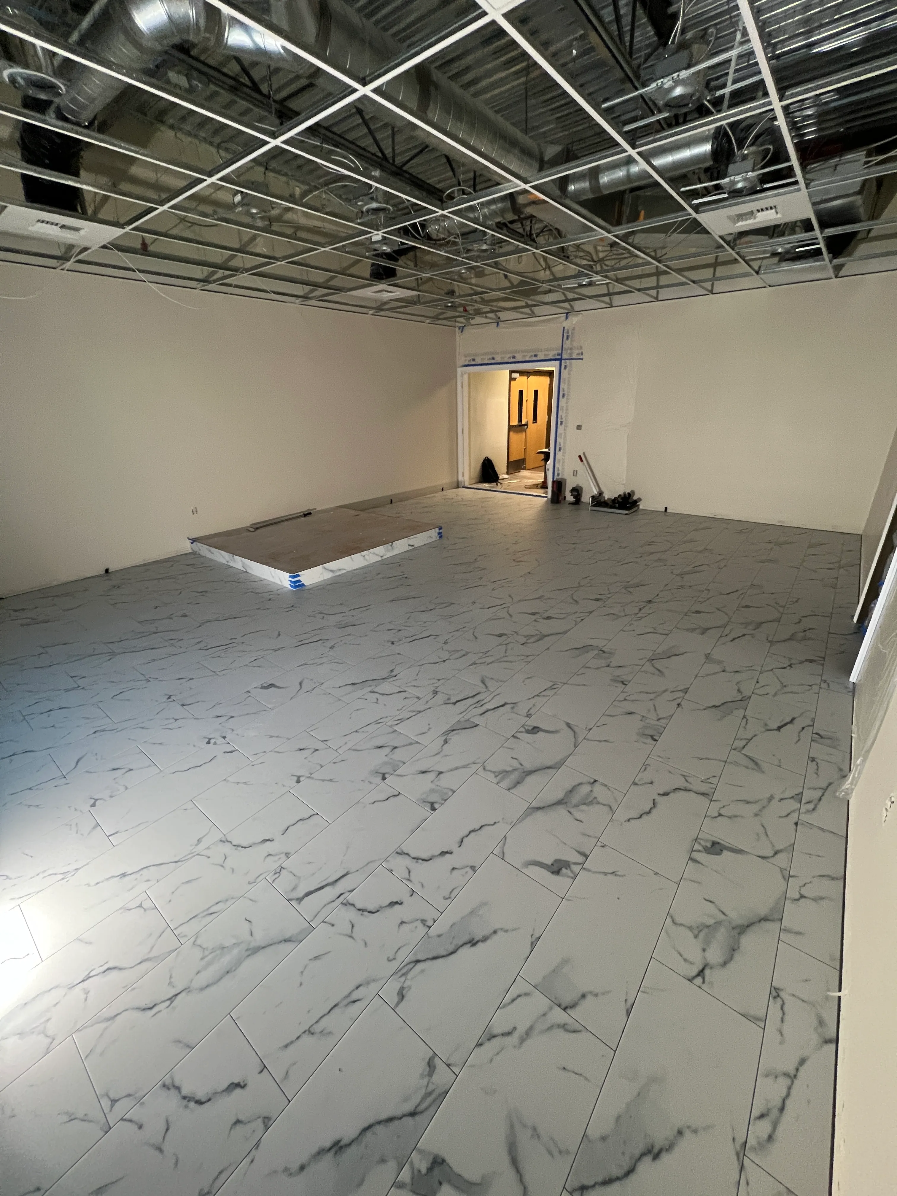 Marble tile wall installation progressing