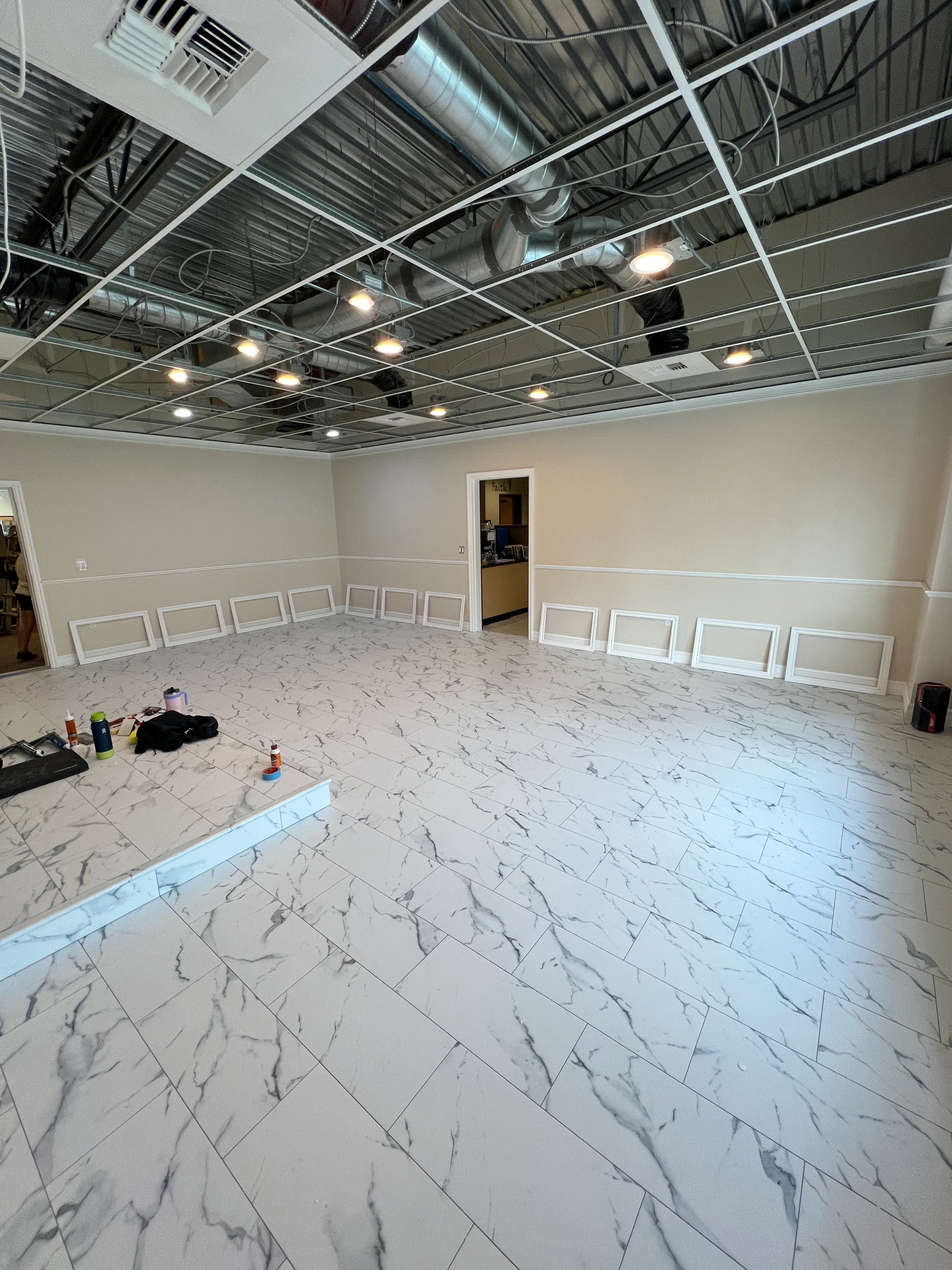 Marble tile wall with coffered ceiling taking shape