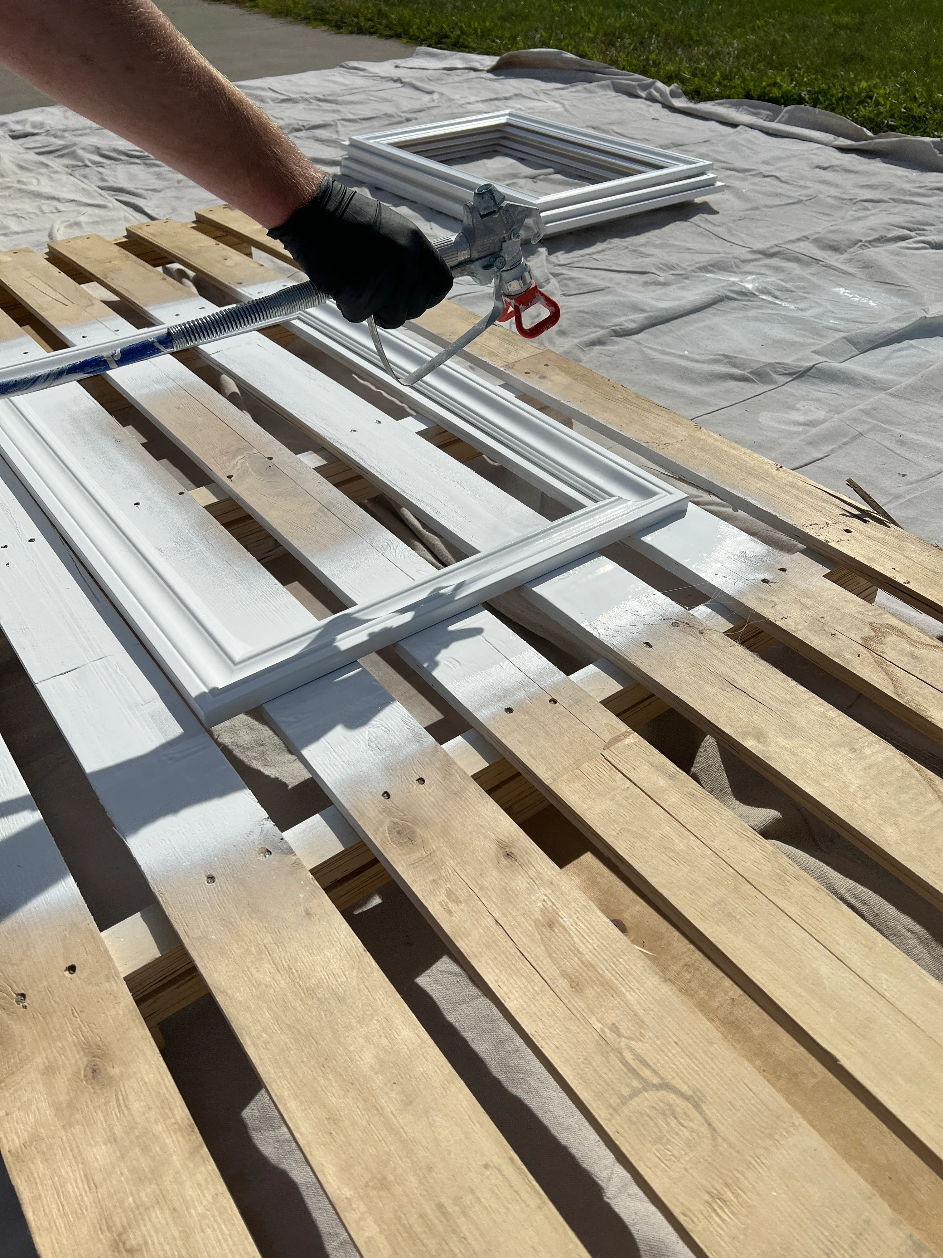 Wainscoting panel frames being spray painted