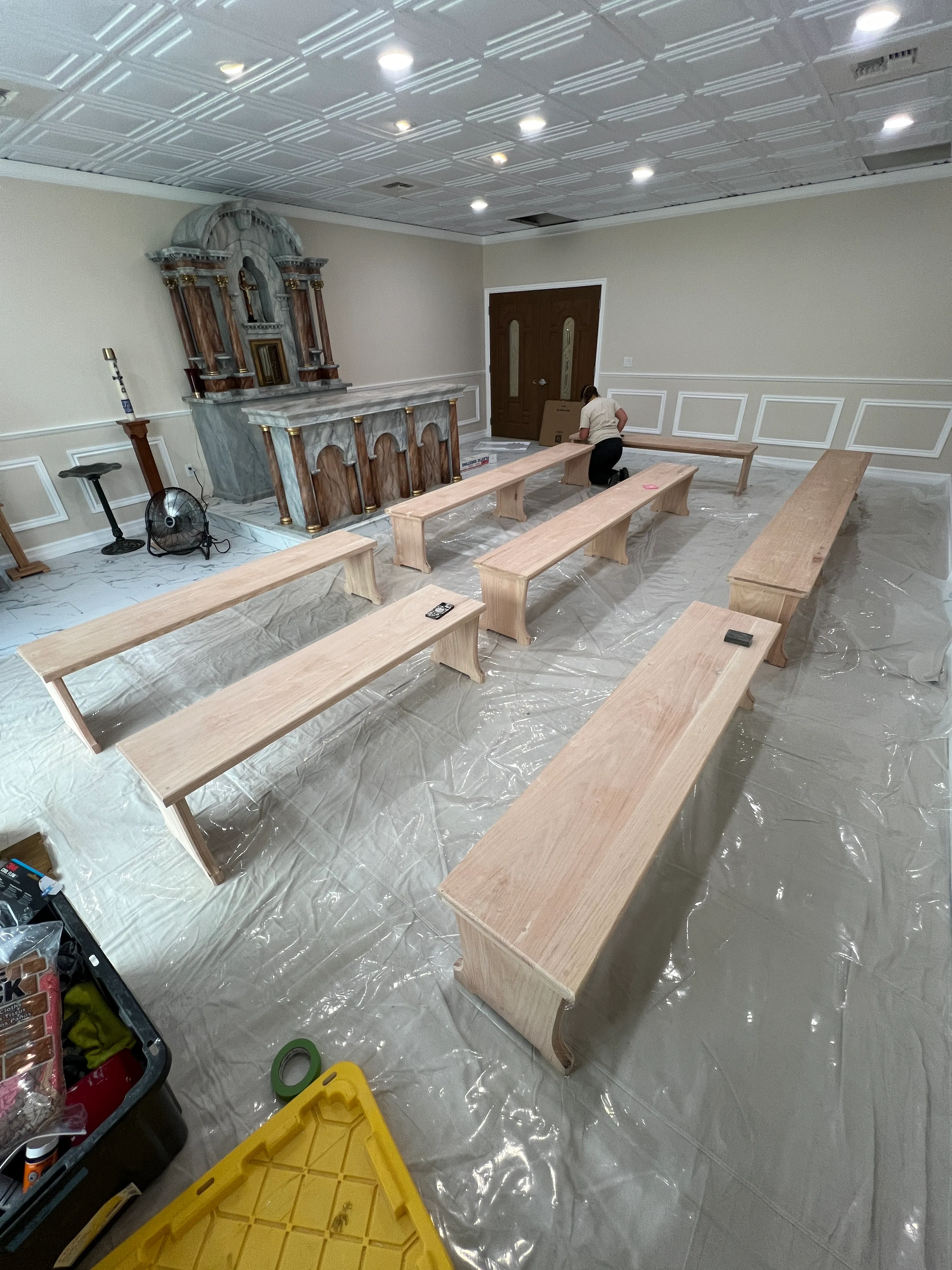 Raw oak benches placed in the chapel before staining