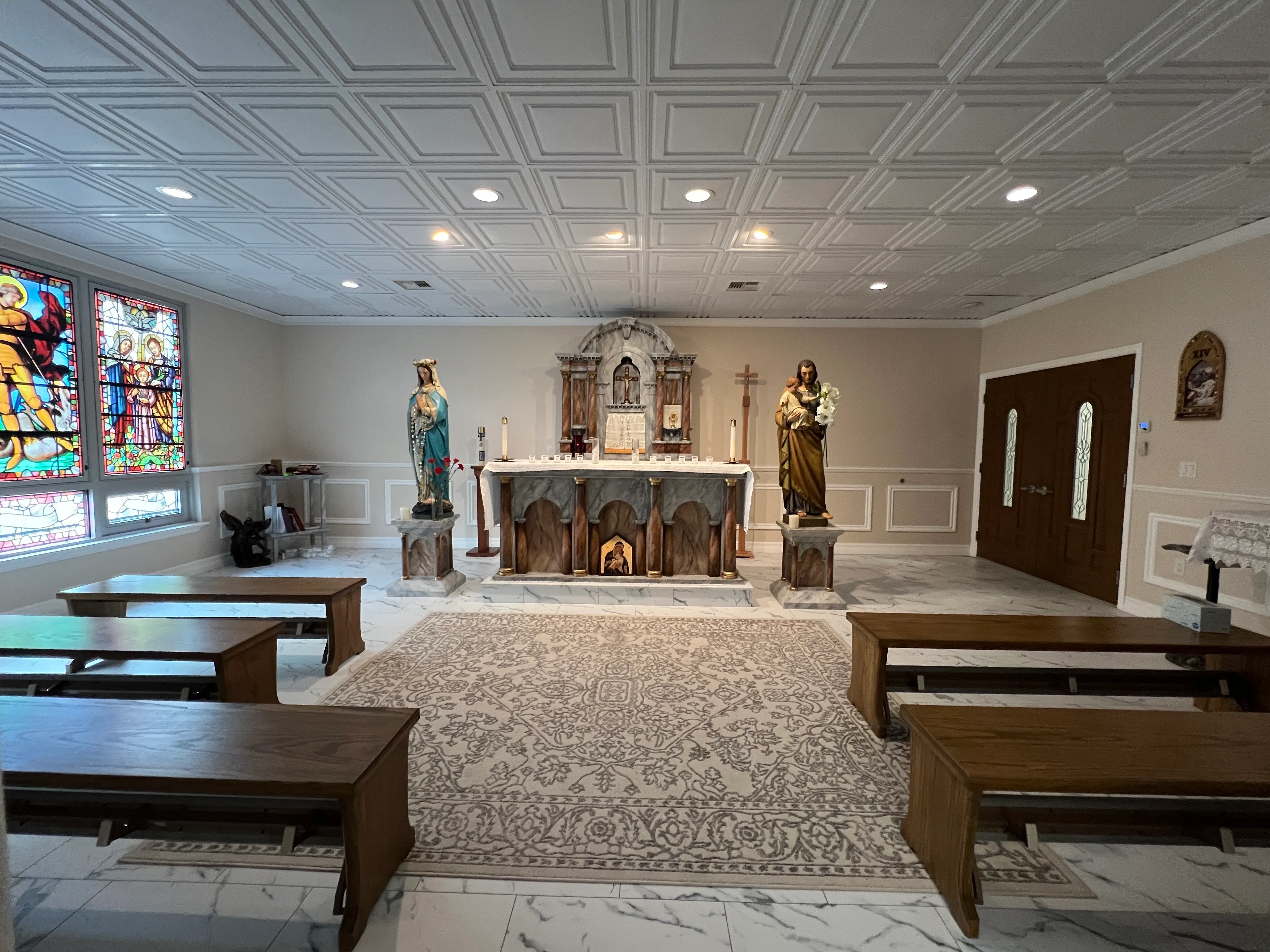Completed adoration chapel with altar, benches, and stained glass