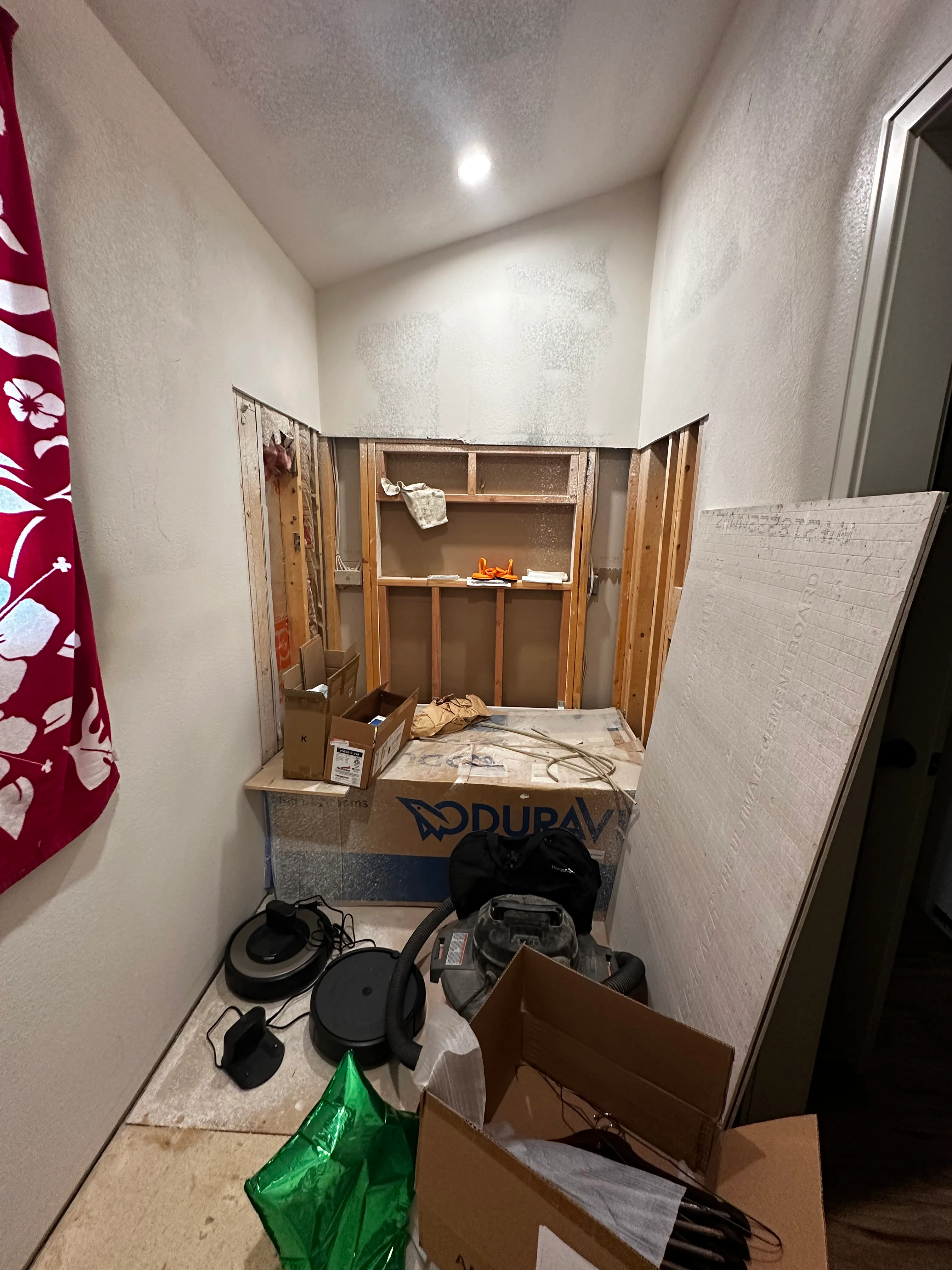 Bathroom demolition showing opened wall framing