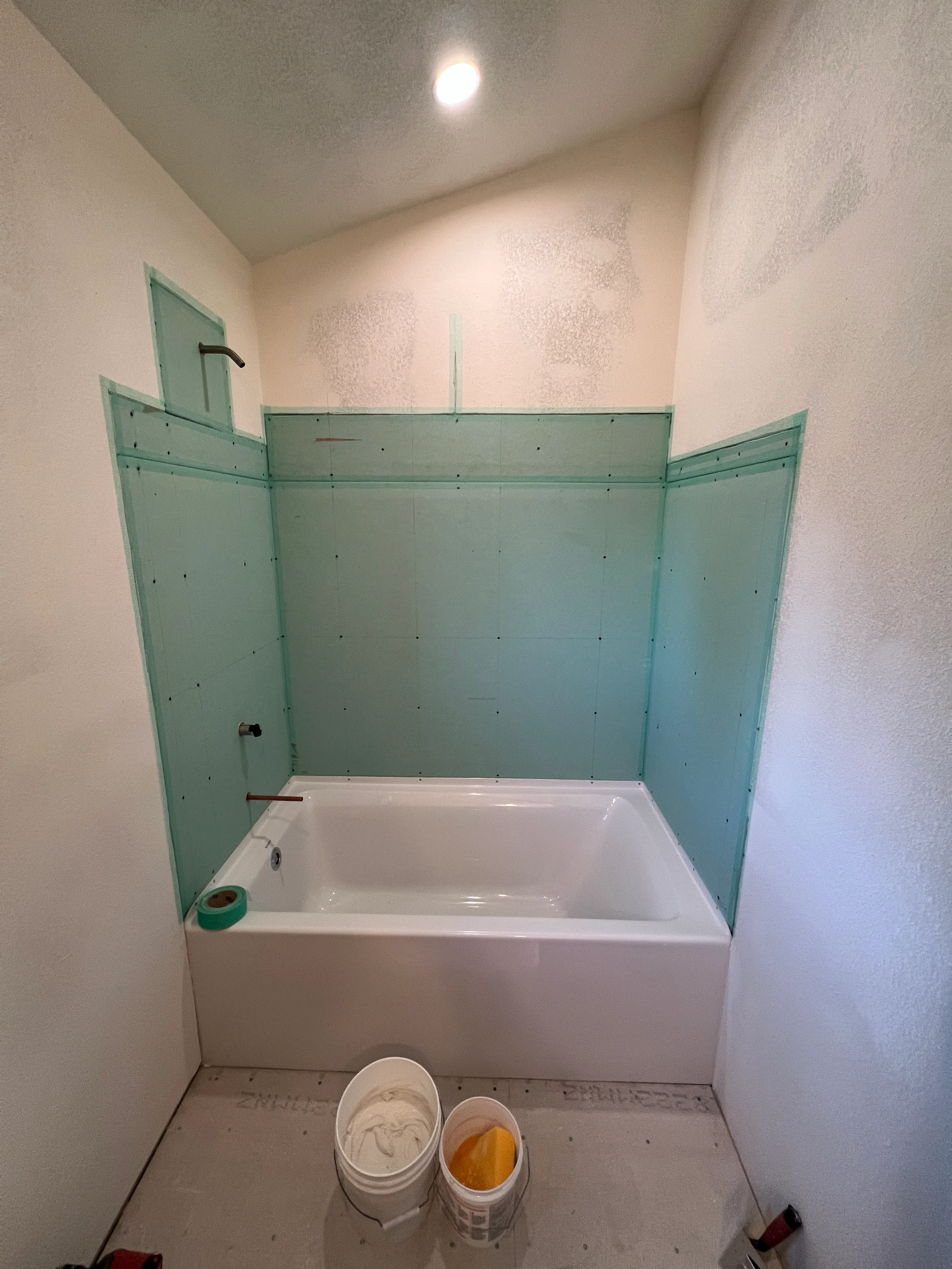 Cement board and tub installation in progress