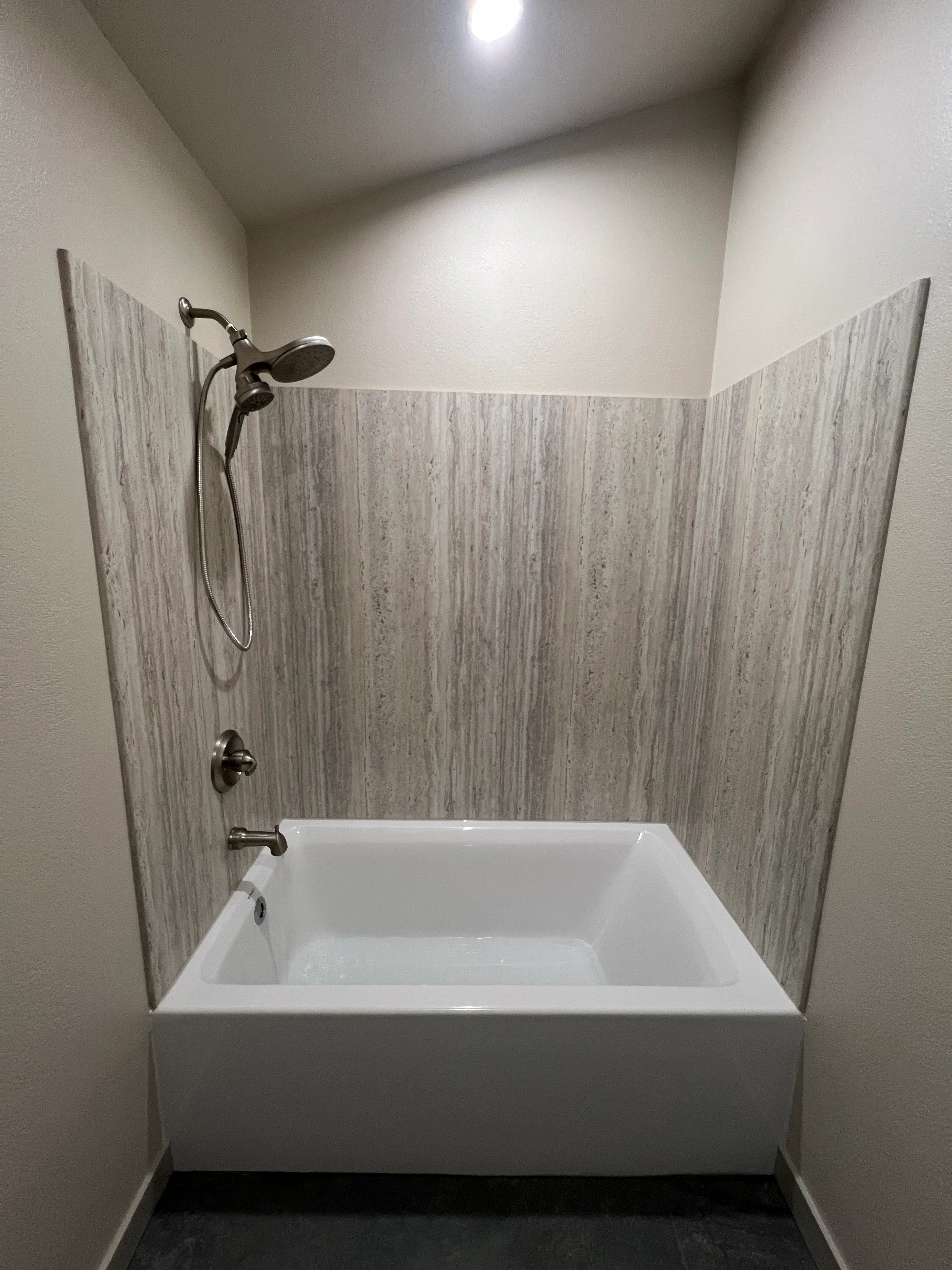 Travertine tile tub surround with soaker tub