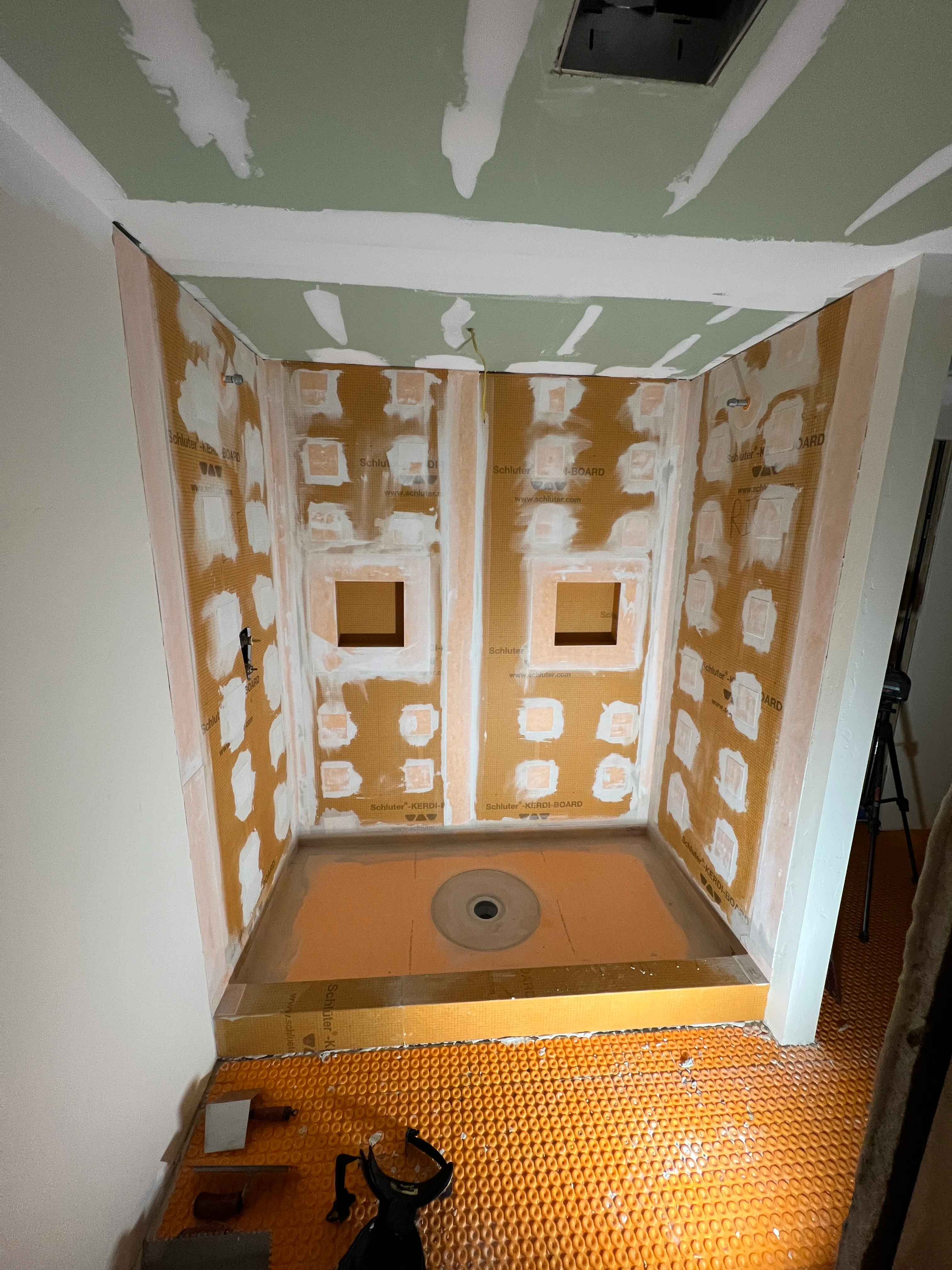 Yurt shower tile installation with Schluter waterproofing
