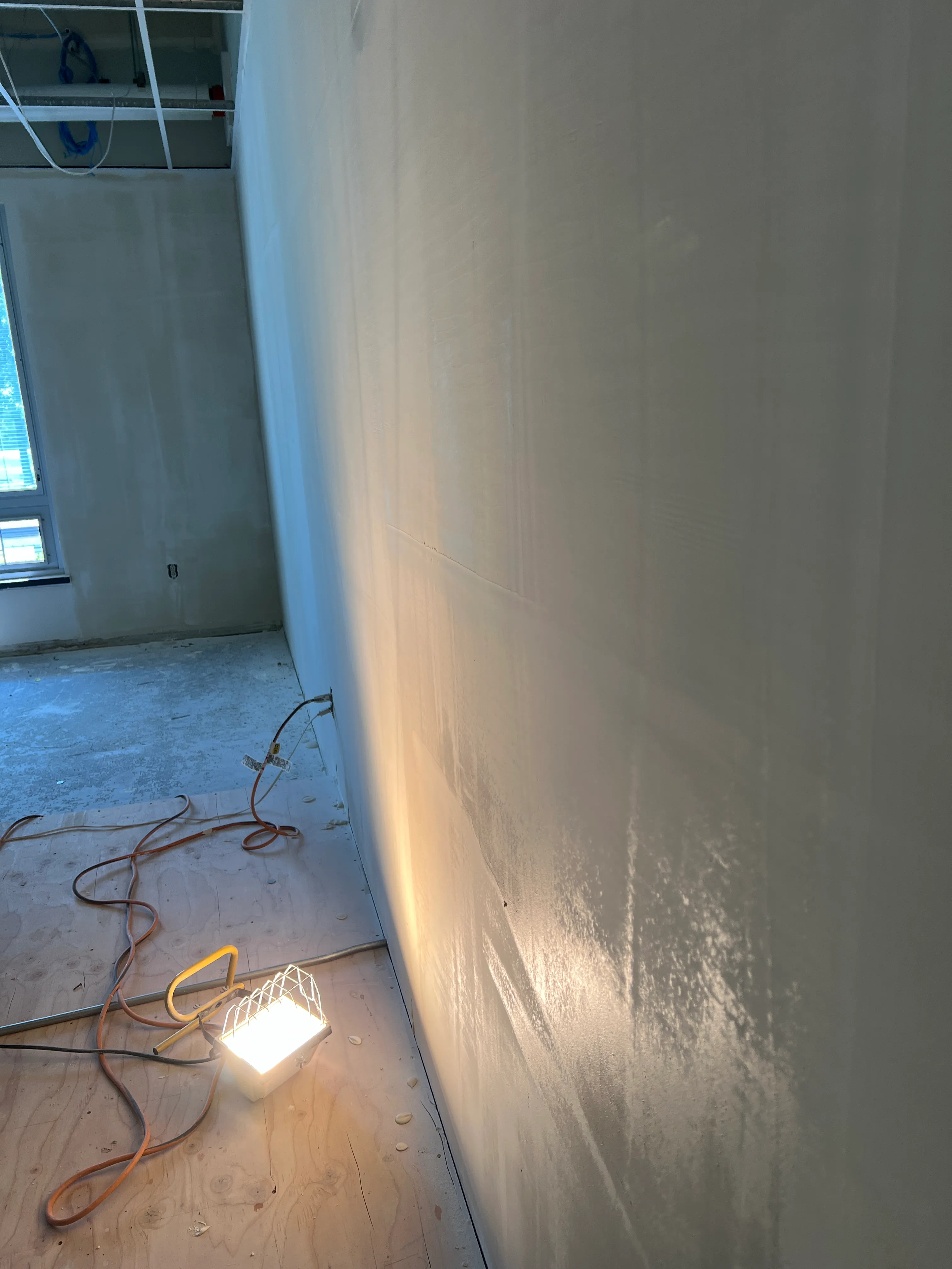 Drywall being skim coated to a level 5 finish