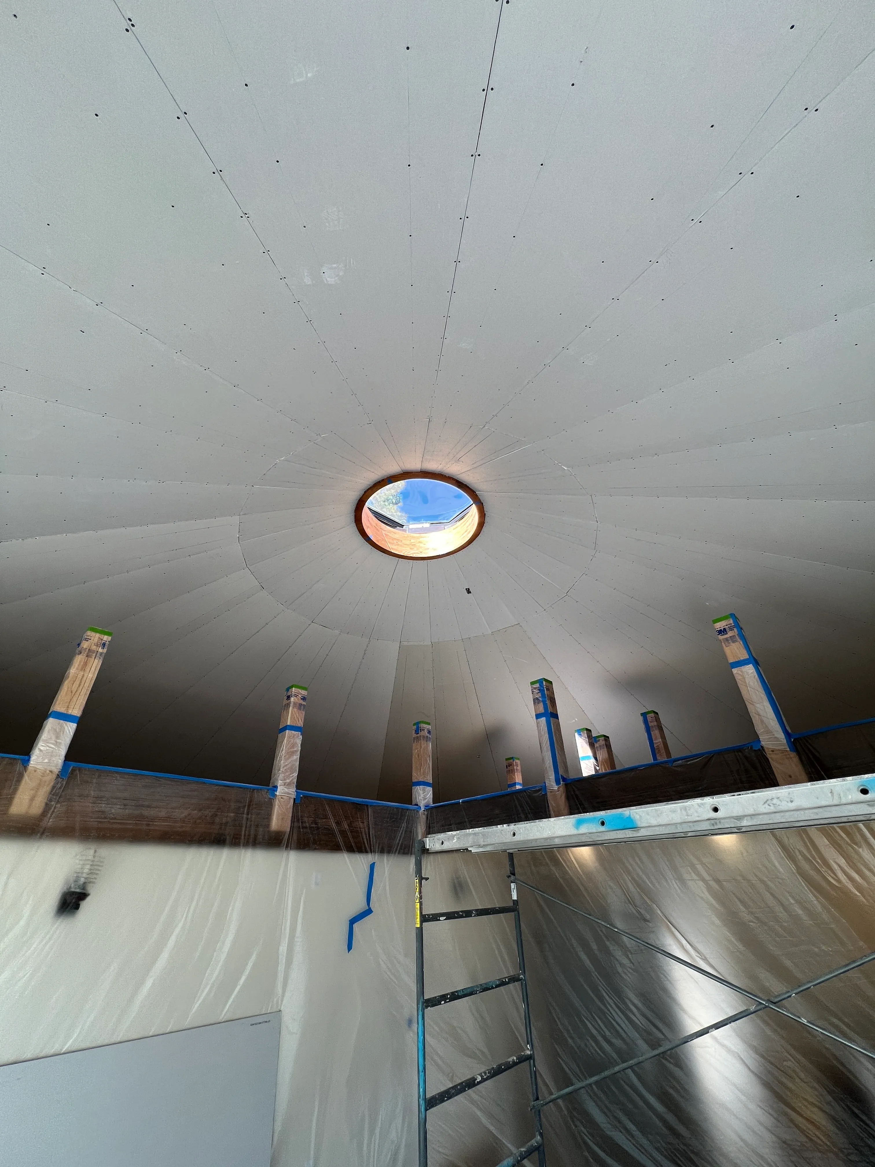 Dome drywalled with circular skylight opening